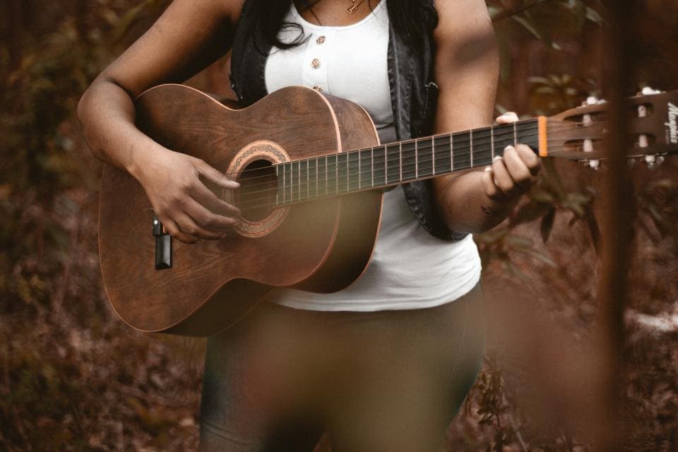 Young woman playing the guitar