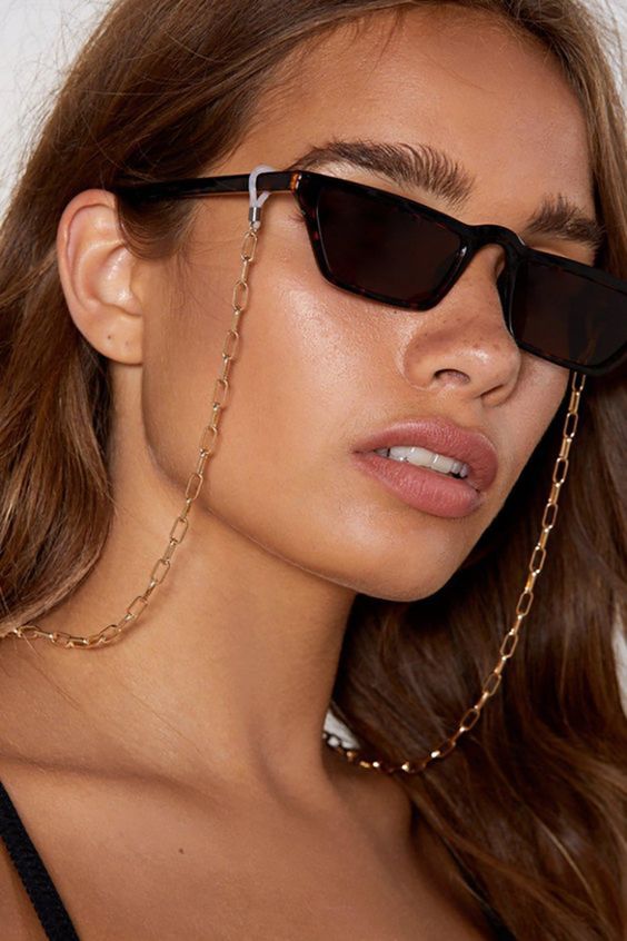 Gold sunglasses chain from Nasty Gal, titled "It's Chain to See"
